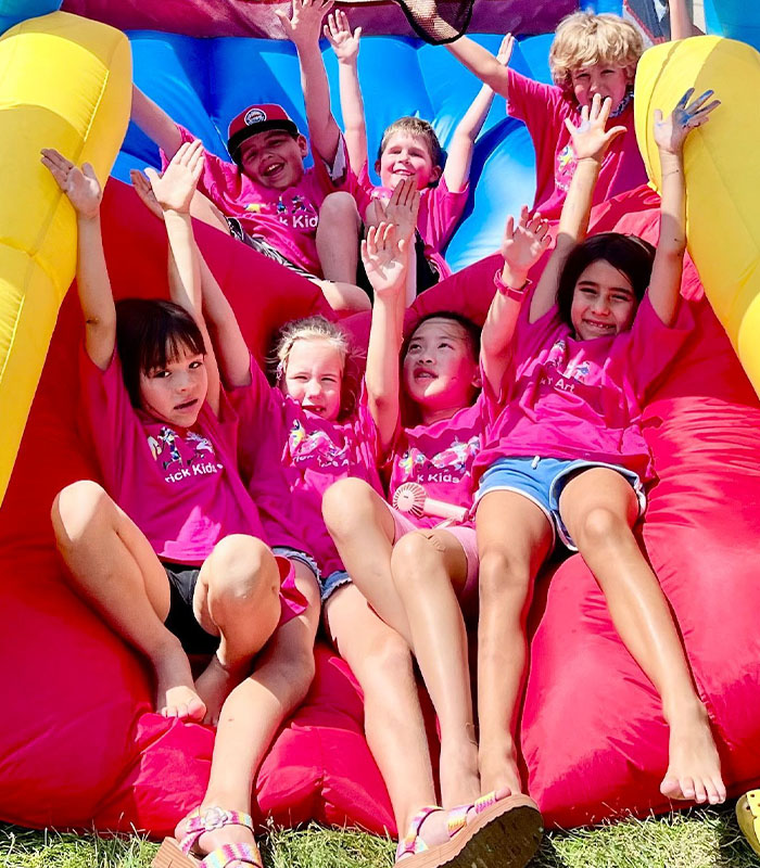 Little kids playing on infallible slide