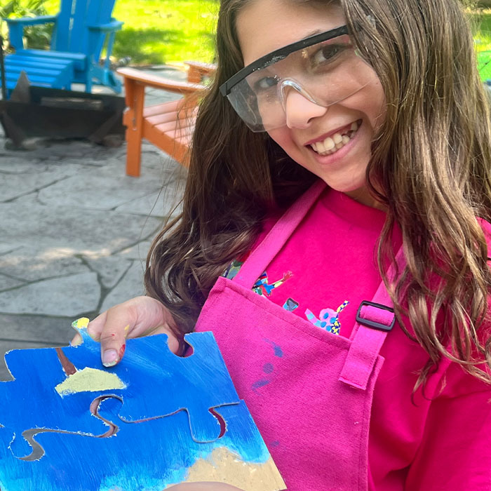 Little girl showing off her new puzzle
