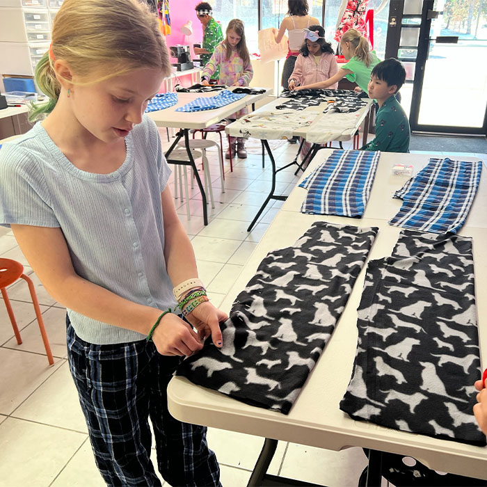 Little girl sewing new pajamas